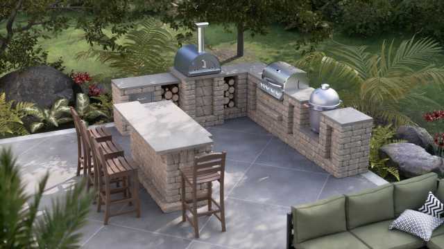 Spacious U-shaped outdoor kitchen with detached bar, featuring a pizza oven, Kamado grill, and Summerset Sizzler grill.