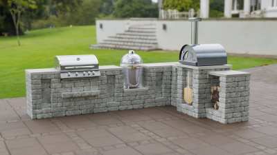 L shaped outdoor kitchen with Grill Camado and pizza oven.