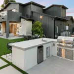 Large modern dream home with small functional outdoor kitchen.