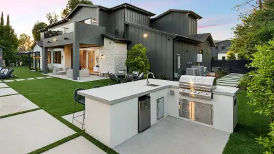 Large modern dream home with small functional outdoor kitchen.