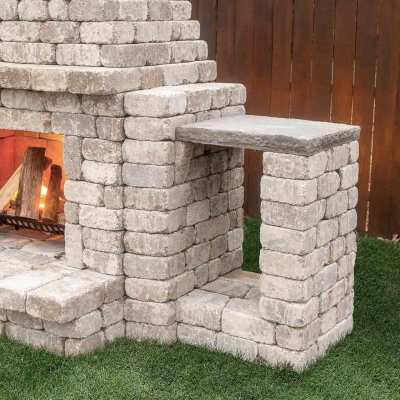 Outdoor fireplace kit with wood storage box and modular stone side optio